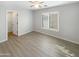 Well lit bedroom with wood-look floors and closet at 2014 N 94Th Gln, Phoenix, AZ 85037