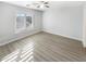 Well-lit bedroom with wood-look floors and a large window at 2014 N 94Th Gln, Phoenix, AZ 85037