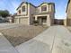 Two-story house with a three car garage and desert landscaping at 2014 N 94Th Gln, Phoenix, AZ 85037