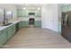 Modern kitchen with mint green cabinets and quartz countertops at 2014 N 94Th Gln, Phoenix, AZ 85037