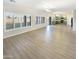 Bright living room with light wood floors and open concept kitchen at 2014 N 94Th Gln, Phoenix, AZ 85037