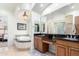 Elegant bathroom with double sinks, a large soaking tub, and a glass shower at 20334 E Colt Dr, Queen Creek, AZ 85142