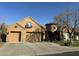 Two-story home with a three car garage and front yard landscaping at 20334 E Colt Dr, Queen Creek, AZ 85142