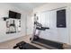 Bright home gym with treadmill, weight bench, and ample storage at 20334 E Colt Dr, Queen Creek, AZ 85142