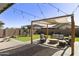 Landscaped backyard with pergola, seating area, and putting green at 20409 E Escalante Ct, Queen Creek, AZ 85142