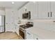 Modern kitchen with stainless steel appliances and white shaker cabinets at 20409 E Escalante Ct, Queen Creek, AZ 85142