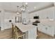 Modern kitchen with white cabinets, quartz countertops, and a large island at 20409 E Escalante Ct, Queen Creek, AZ 85142