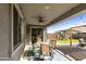 Covered patio features dining area, ceiling fan, and string lights at 20409 E Escalante Ct, Queen Creek, AZ 85142