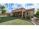 Covered patio overlooks a grassy backyard with desert landscaping at 2147 S Valle Verde Cir, Mesa, AZ 85209