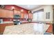 Spacious kitchen with granite countertops and wood cabinets at 2147 S Valle Verde Cir, Mesa, AZ 85209