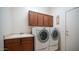 Laundry room with washer, dryer, and built-in cabinets at 2147 S Valle Verde Cir, Mesa, AZ 85209