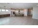 Spacious, modern kitchen with white cabinetry, stainless steel appliances, and a large center island at 21569 W Pierson St, Buckeye, AZ 85396