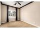 This bedroom is carpeted and features dark trim, ceiling fan and a window for natural light at 21804 N 38Th Pl, Phoenix, AZ 85050