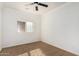 This carpeted bedroom includes a window with plantation shutters and a ceiling fan at 21804 N 38Th Pl, Phoenix, AZ 85050