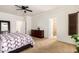 Bedroom featuring a ceiling fan, hardwood floors, a large dresser and a doorway to the bathroom at 21804 N 38Th Pl, Phoenix, AZ 85050