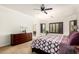 Bedroom featuring hardwood floors, a window with wooden shutters and a dark dresser at 21804 N 38Th Pl, Phoenix, AZ 85050