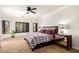 Spacious bedroom with a ceiling fan, a window with wooden shutters and a mirrored night stand at 21804 N 38Th Pl, Phoenix, AZ 85050