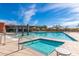 Large community pool with a separate spa, surrounded by lounge chairs and shade umbrellas at 21804 N 38Th Pl, Phoenix, AZ 85050