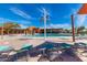 Resort-style pool with lounge seating, shade structures, and well-maintained landscaping at 21804 N 38Th Pl, Phoenix, AZ 85050