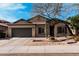 Charming single-story home with a two-car garage, desert landscaping, and a stone accented front entrance at 21804 N 38Th Pl, Phoenix, AZ 85050