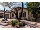 Attractive single-story home with lush desert landscaping, a stone-accented entrance, and a two-car garage at 21804 N 38Th Pl, Phoenix, AZ 85050