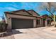 Attractive single-story home with a desert landscaped front yard, and a two-car garage and concrete driveway at 21804 N 38Th Pl, Phoenix, AZ 85050