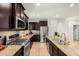 Gourmet kitchen featuring granite countertops, stainless steel appliances, and dark wood cabinetry at 21804 N 38Th Pl, Phoenix, AZ 85050