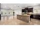 Kitchen view showcasing island with bar, stainless appliances, and marble floors at 21804 N 38Th Pl, Phoenix, AZ 85050