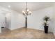 Bright living area with neutral walls, travertine floors, and decorative chandelier at 21804 N 38Th Pl, Phoenix, AZ 85050