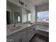 Modern bathroom with double vanity, large soaking tub, and window at 22216 W Skinner Rd, Wittmann, AZ 85361