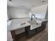 Kitchen island with white quartz countertop and dark brown cabinets at 22216 W Skinner Rd, Wittmann, AZ 85361