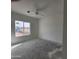 Simple bedroom with large window and ceiling fan at 22232 W Skinner Rd, Wittmann, AZ 85361