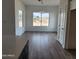 Bright dining room with large window and hardwood floors at 22232 W Skinner Rd, Wittmann, AZ 85361