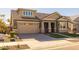 House exterior showcasing a two-car garage and stone accents at 22897 E Carriage Way, Queen Creek, AZ 85142