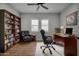 Home office features built-in shelving and leather chairs at 22897 E Carriage Way, Queen Creek, AZ 85142