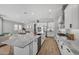 Modern kitchen with white cabinets, granite countertops, and stainless steel appliances at 22897 E Carriage Way, Queen Creek, AZ 85142