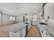 Modern kitchen with white cabinets, granite countertops, and stainless steel appliances at 22897 E Carriage Way, Queen Creek, AZ 85142