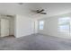 Spacious bedroom with ceiling fan and neutral carpeting at 25565 W Gwen St, Buckeye, AZ 85326