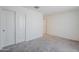 Bedroom with double-door closet and neutral carpeting at 25565 W Gwen St, Buckeye, AZ 85326