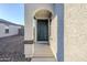 Front entry with arched alcove and dark green door at 25565 W Gwen St, Buckeye, AZ 85326