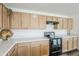 Modern kitchen with light wood cabinets and gas range at 25565 W Gwen St, Buckeye, AZ 85326