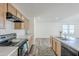 Eat-in kitchen with island, double sink, and light wood cabinets at 25565 W Gwen St, Buckeye, AZ 85326