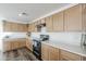 Modern kitchen with light wood cabinets and stainless steel appliances at 25565 W Gwen St, Buckeye, AZ 85326