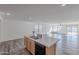 Open concept kitchen with island and stainless steel dishwasher, offering a view of the living room at 25565 W Gwen St, Buckeye, AZ 85326