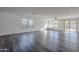 Spacious living room featuring wood-look floors and sliding glass doors to patio at 25565 W Gwen St, Buckeye, AZ 85326