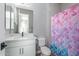 Bathroom featuring a white vanity, toilet, and colorful mermaid-themed shower curtain at 2560 E Thornton Ct, Gilbert, AZ 85297