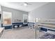 Well-lit bedroom with bunk beds, study area, and built-in shelving for storage and display at 2560 E Thornton Ct, Gilbert, AZ 85297