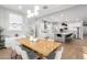 Elegant dining room with wood table and view of the modern kitchen and white cabinets at 2560 E Thornton Ct, Gilbert, AZ 85297