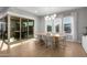 Elegant dining room filled with natural light, featuring a modern chandelier, and patio access at 2560 E Thornton Ct, Gilbert, AZ 85297