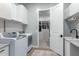 Bright laundry room with white cabinets, sink, and modern washer and dryer visible at 2560 E Thornton Ct, Gilbert, AZ 85297